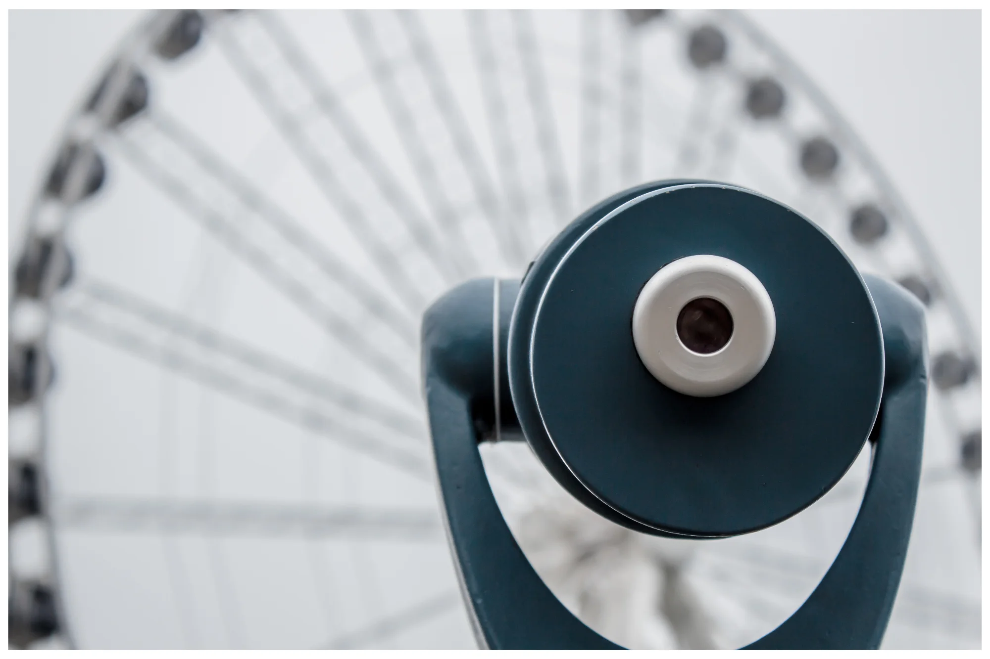 Telescope overlooking a ferris wheel